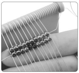 Two rows of beads on a loom